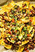 Gratinated nachos with minced meat, jalapeños and cheese