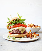 A cheeseburger with veggies fries made in a hot-air fryer