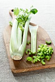Celery on wooden chopping board
