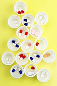 Pills in paper medicine pots