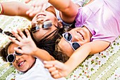 Girls lying on blanket in park