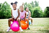 Girls bouncing on inflatable hopper