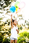 Girl holding balloons