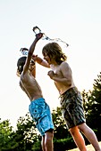 Boys pouring water