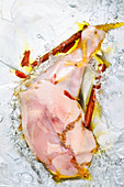 Vacuum-packed chicken leg with spices in water