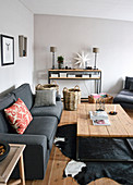 Grey couch, coffee table and festively decorated sideboard in living room