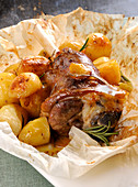 Oven-roasted knuckle of lamb with potatoes and rosemary