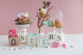 Easter arrangement of lettered cubes and jars, Easter nest, bird, feathers, butterfly and sugar eggs