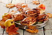 Apple pies with puff pastry and autumn leaves