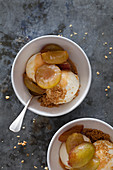 Greengage crumble with ice cream in bowls