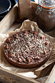 Hazelnut topped chocolate torte in a vintage tray