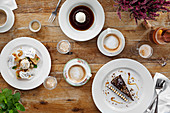Selection of delicious desserts spread out on a table with coffee and champagne