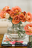 Strauß rostrote Rosen in einer zylindrischen Glasvase