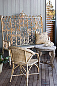 Wicker chair, table with elephant-head legs and ornate metal bench
