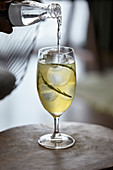 A samphire and tonic cocktail being poured