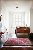 Rug and antique cabinet on landing in period building