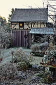Wintry garden with barn in background