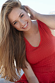 A young blonde woman wearing a red dress