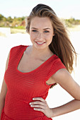 A young blonde woman wearing a red dress