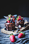 Tasty sweet chocolate cakes decorated with different berries