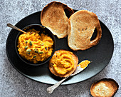 Roasted pumpkin dip with a serving on toasted bread
