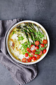 Green asparagus, cherry tomatoes and chervil gratin