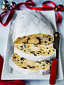Iced German Stollen Christmas bread with nuts spices and dried fruit