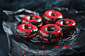 Beetroot donuts with two-tone chocolate icing for Halloween