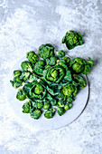Fresh brussels sprouts on a marble tray