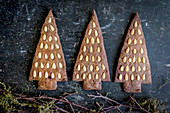 Gingerbread Christmas tree biscuits decorated with pine nuts