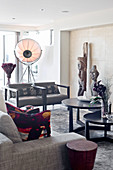 Grey sofa set, round tables, artworks and studio lamp