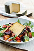 Warm cheese on roasted autumnal vegetables