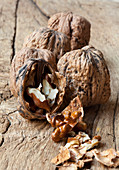 Walnuts in shells, with one opened