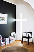 Light falls through the cross-shaped wall opening