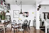 Bistro chairs around a round dining table in an open living room