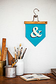 Handmade pennant above vintage desk