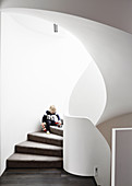 Boy plays on organically shaped, brick stairs