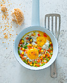 Fried eggs with colourful vegetables