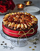 Classic Christmas cake with walnut brazil pecan nut glazed topping roses and candles