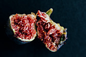 A fig broken in front of a black background