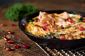 Fish and kale frittata with pomegranate seeds