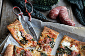 Pizza with black kale, salsiccia and roasted garlic