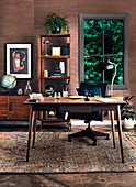 Desk, sideboard and open shelf in the study with dark wood paneling