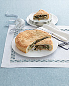 Southern Italian-style stuffed pizza with chicory, anchovies, capers and olives