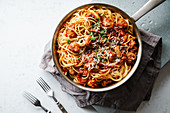 Spaghetti with meatballs, tomato sauce, parsley and cheese