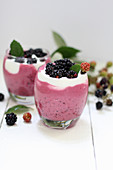 Berry yoghurt with blackberries in glasses