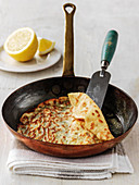 Crepe suzette in pan with half lemon