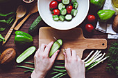 Assortment of red and green ripe vegetables and wooden cutting board