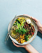 Green and gold rice bowls with tuna