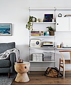 Side table made of solid wood in front of the designer shelf with retro radio